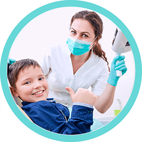 Little girl smiling and giving two thumbs up at dentist