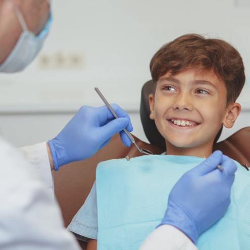 Child smiles at dentist