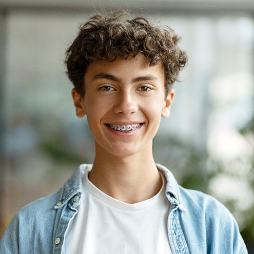 a teenager with braces smiling